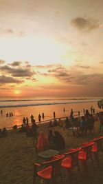 People at beach during sunset