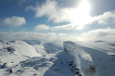 Scenic view of snow covered mountains against sky