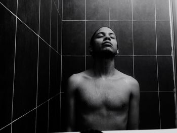 Portrait of shirtless man in bathroom