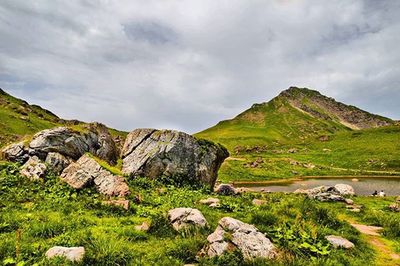 Scenic view of mountains against cloudy sky