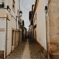 Narrow alley amidst buildings in city