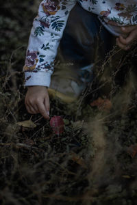 Low section of woman standing on field