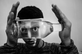 Close-up portrait of boy holding a bottle of water 