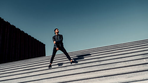 Low angle view of man against clear sky