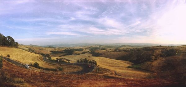 Scenic view of landscape against cloudy sky