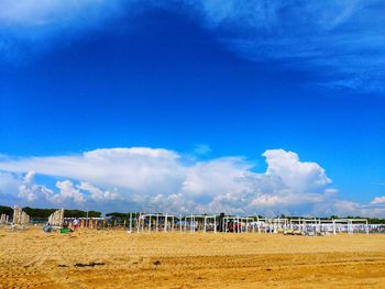 Scenic view of beach against blue sky