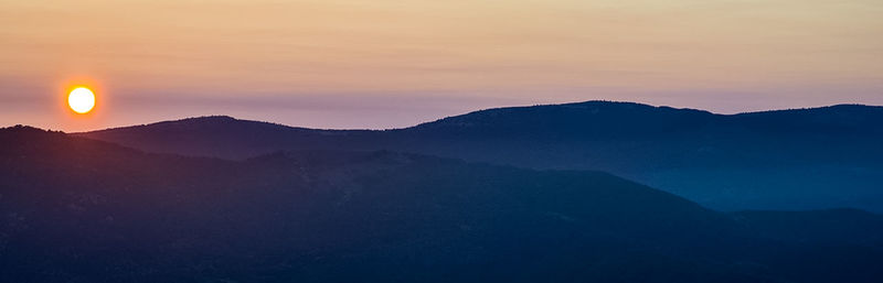 Scenic view of silhouette mountains against sky during sunset