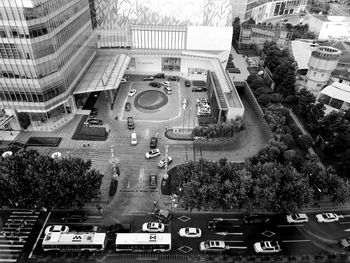 High angle view of vehicles on road along buildings