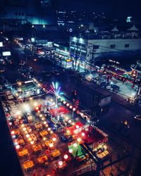 High angle view of city lit up at night