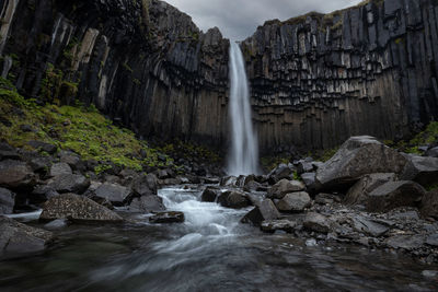 Famous savrtifoss waterfall and black basalt columns in skaftafell national park in southern iceland