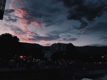 Silhouette city against sky at sunset