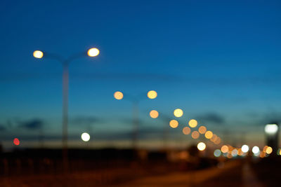 Defocused image of illuminated street lights at night