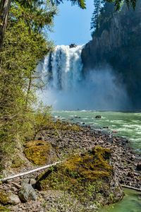 A view of snoqualmie falls from downriver in washington state.