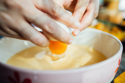 Close-up of person preparing food in bowl