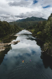 High angle view of river amidst trees against sky