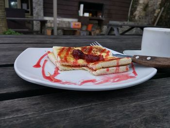 Close-up of jam and pancake served on table