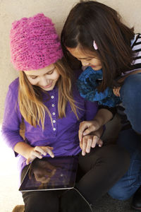 Portrait of two girls with digital tablet