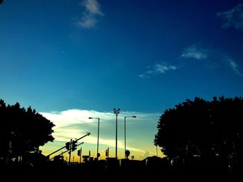 Low angle view of silhouette trees against sky