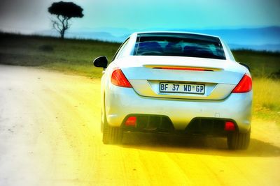 Close-up of car on road against sky