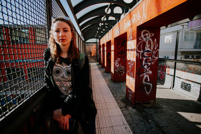 Portrait of young woman standing in city