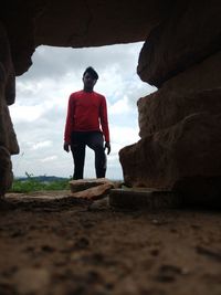 Rear view of man standing on rock
