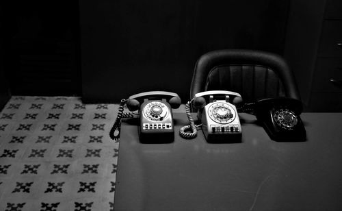 High angle view of telephones on table in darkroom
