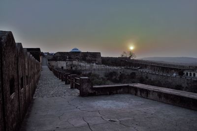 Walkway against clear sky