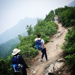 Full length of woman standing on rocky mountain