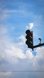 Low angle view of road signal against sky