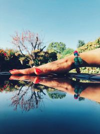 Cropped hand of woman on glass table