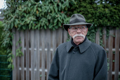 Portrait of man standing against plants