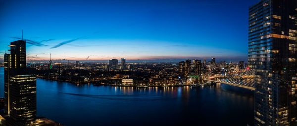 Illuminated city at waterfront