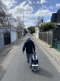 Rear view of man on street in city