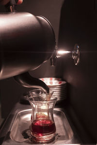 Close-up of wine pouring in glass