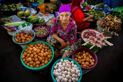 High angle view of woman selling food at market stall
