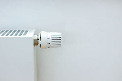 Close-up of security camera against white background