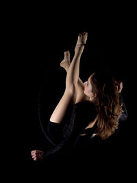 Close-up of woman hand against black background