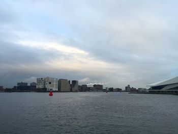 Buildings against cloudy sky