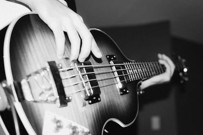 Midsection of man playing guitar