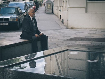 Full length of woman standing by railing