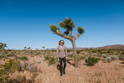 Full length of man on field against clear sky