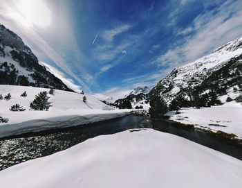 Scenic view of snow covered mountains against sky
