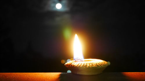 Close-up of illuminated candles on table