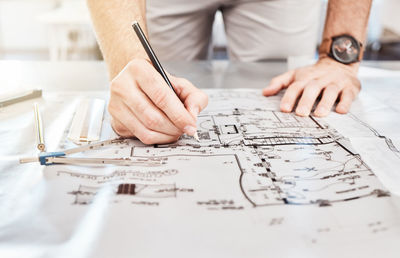 Midsection of man working on table