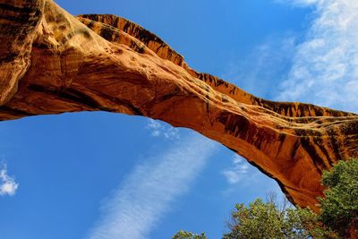 Low angle view of arch bridge against blue sky