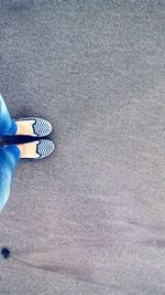 Low section of woman standing on road