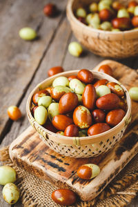 Close-up of fruits in basket on cutting board