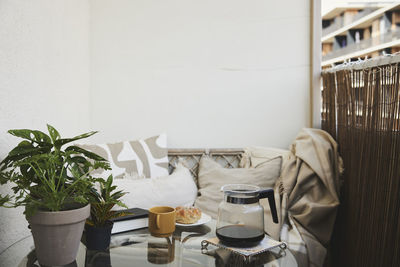 Jug of coffee on table on balcony