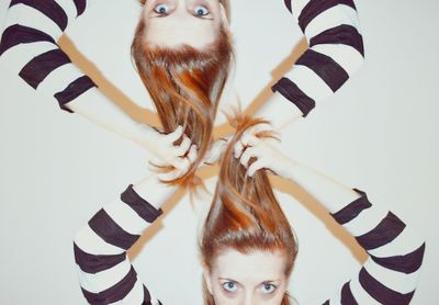 Multiple image of woman holding brown hair against white background