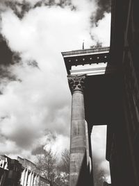 Low angle view of building against cloudy sky